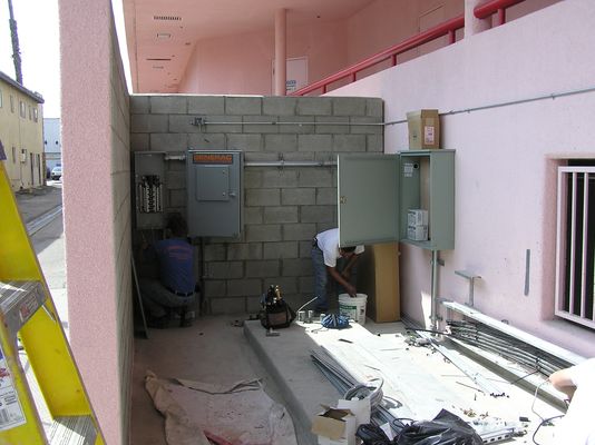 14. Installing the Telco Interface and Power Switching Cabinets
The large cabinet on the right (with the open door) is to house the telco interface.  A telco dataline is used to connect this cell site back to Verizon's mobile telephone switching office.  The two smaller cabinets on the left, starting at the far left, are the power breaker panel, and the power generator transfer switch.  The transfer switch senses loss of commercial power and automatically starts the generator (yet to be installed) and transfers power to the generator once stabilized.  The reverse occurs when the commercial power is restored for a minimum period of time.
Keywords: verizon armacost