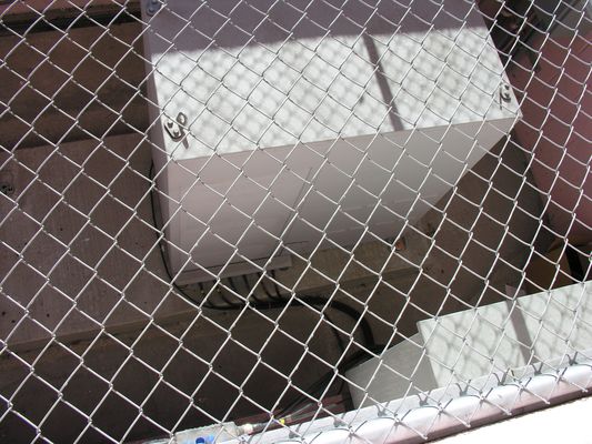 30. BTS Installed and Humming
The site is active.  This photo is looking down on the site BTS equipment cabinet through the roof fence.  You'll see more of the fense in a later photo.
Keywords: verizon armacost