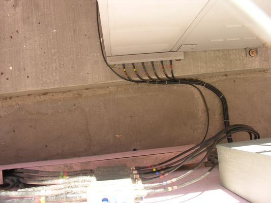 31. Cable Termination to BTS Jumpers
Here's a nice photo of the the cable terminations for the hardline cable to/from the roof, and the jumper to the equipment cabinet.  The colored bands identify what cable is connected to what antenna.
Keywords: verizon armacost
