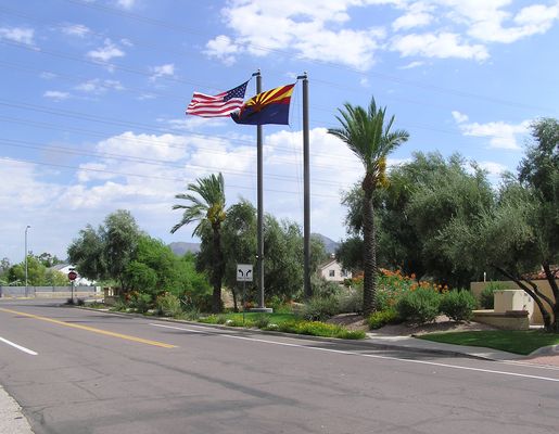 Proud Waves From Sprint (1 of 3)
Sprint has created this very nice flagpole site at the Scottsdale Ranch Community Center in Scottsdale, Arizona.  Note that each flagpole has a light illuminating the other flagpole's flag.  The flags are in good condition.  The equipment enclosure is the right in the photo (look for the GPS antenna).  Points to Sprint for this design, save for the visible GPS antenna which should have been hidden.
Keywords: sprint scottsdale ranch community center arizona flag flagpole pole poles flagpoles