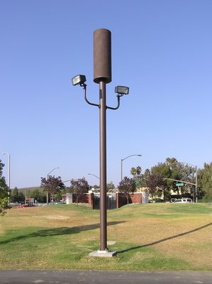Cingular Camo Light Standard
At California Lutheran University in Thousand Oaks, California.  The antennas are in the radome atop the parking lot lights, and the BTS equipment is in the background behind the monument entry sign.
Keywords: California Lutheran University thousand oaks camo light standard parking cingular