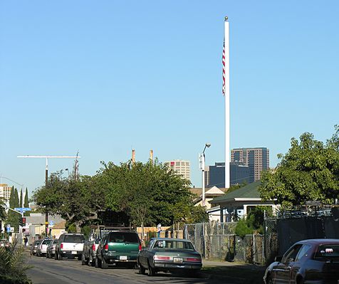 A Flag and Light Show
This is an AT&T Wireless site, later Cingular, shining signal in San Diego on the I-5 Freeway and the Coronado Bay Bridge.  The light standard also supports antennas. 
Keywords: flagpole att cingular san diego light standard