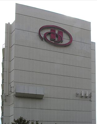 Multi-carrier Cell Site Cleverly Disguised As An Upscale Hotel
Looking south at north wall.  Corner reflector antennas on the left; camo box in left center; naked panels on right (west).  Notice the separate cable chase coming down from the roof to the corner reflector antennas.
Keywords: multicarrier torrance hotel hilton