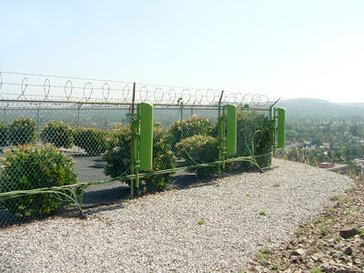 Not too compliant with the FCC OET Bulletin 65 Rules
The FCC rules require that where visitors (and even trespassers) are expected, a wireless carrier must protect those members of the general population from RF exposure exceeding the uncontrolled standard.  This site does not meet that requirement due to the antennas mounted on the exterior fence of this water tank site.
Keywords: fcc oet bulletin 65 rf safety water tank fence antennas