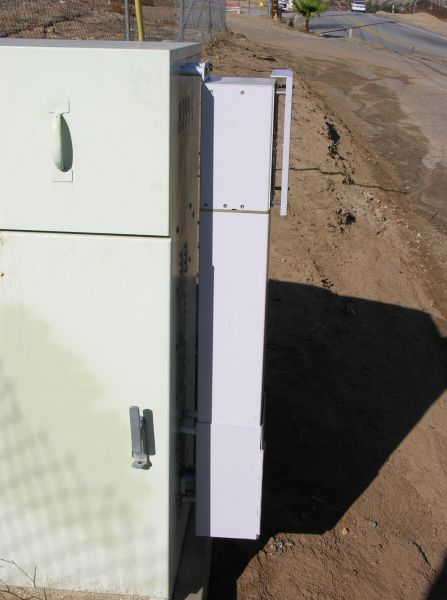 Das da ticket!
AT&T uses a distributed antenna system (DAS) to light this site on Valley Circle in the San Fernando Valley (Los Angeles County).  The DAS node, manufactured by Andrew Corporation, is the small box affixed to the larger power meter pedestal cabinet.  Notice that the node is not directly affixed, but is held via stand-offs.
Keywords: das distributed antenna system node andrew corporation power meter pedestal cabinet stand off mount