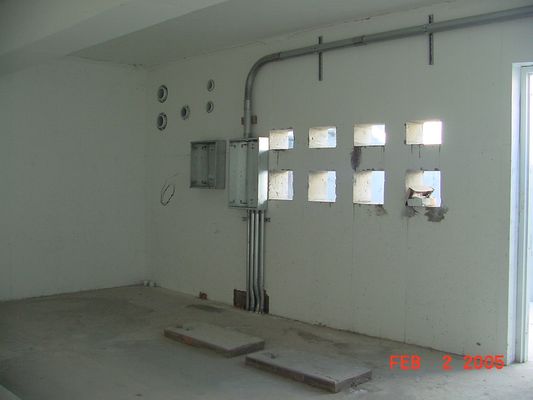 View inside the Transmitter Vault
Here's a view facing southwest inside the equipment vault.  The large openings are for air conditioning.  The cable conduit entry ports can be seen in the upper-far corner of the same wall. Photo by Bill Cloutier.
Keywords: kmlt equipment air conditioning cable conduits Bill Cloutier