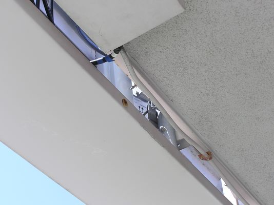 Major Co-lo Site - San Clemente, California
Co-location camo site (Sprint, Verizon, Nextel, Cingular) at St. Andrews by the Sea United Methodist Church, San Clemente.

This camo sector shines to the east.  You can see one of the antennas for this sector located behind RF transparent panels just below the roof.  The arrows indicate the direction of installation of one of the antennas.  The color tape on the coaxial cable is a typical method of identifying the sector of the antenna, and whether its a transmit, receive, or duplex model.
Keywords: Sprint, Verizon, Nextel, Cingular, San Clemente