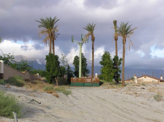 Palms guarding cell site - circa 2004
This is a cell site 'guarded' by live palm trees. Its the same site I photographed in late 2001 (see that photo in this gallery).  Notice how the live palms have grown, and so have the houses around the site!
Keywords: cell site guarded live palm trees