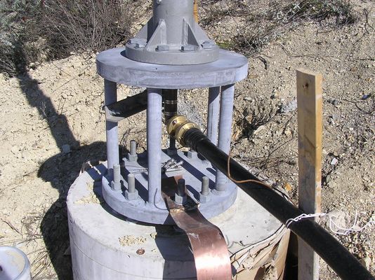 Connecting the coax and ground strap to the antenna and post
The transmitter coaxial cable (black) connects to the rigid coaxial rider inside the antenna support to feed the antenna.  The very wide copper strap provides an unbroken ground connection between the antenna and the underground transmitter building about 700 feet away.
Keywords: KMLT-FM