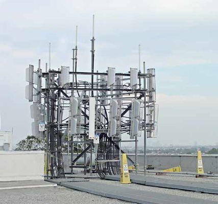Hot zone? What hot zone?
This roof-top site (now removed) used cheezy plastic safety cones with pasted-on warning signs to alleged mark the edge of the general population/uncontrolled RF zone.  Note the two cones at rear-right that have blown over.  A very effective warning technique, eh?
Keywords: Hot zone rf emissions safety cones general population uncontrolled RF