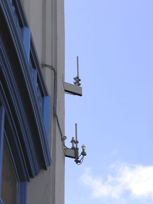 Building side mount omni site
Notice that the omnidirectional antennas are mounted on the side of the building near the corner.  Even more interesting is that the GPS antenna (used for network timing) is mounted in such a way as to be shielded from about 120 degrees of sky (this site faces northwest).
Keywords: building side mount gps