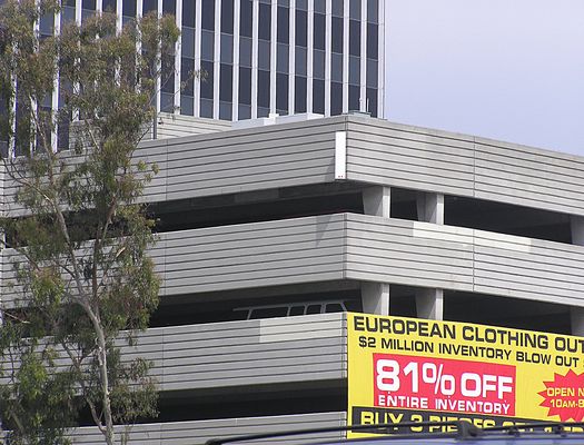 Parking the Signal
Parking spaces make good sites for BTS cabinets, GPS, and LMU equipment!  And parking lot walls are great for mounting panel antennas, especially when the parking lot faces a major freeway.  This site is near LAX airport in Los Angeles along the San Diego Freeway at Century Boulevard.
Keywords: parking lot