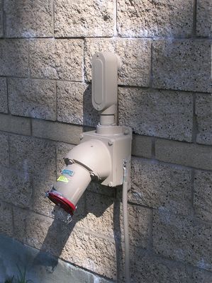 What a Lug!
Nextel's Santa Margarita Christian High School site (Rancho Rancho Santa Margarita, California) is adorned with this emergency generator socket (sometimes called a "LUG").  It permits the Nextel to bring in a portable power generator to keep the site on-air during local power outages.   For technical details regarding this device see:
http://www.appletonelec.com/pdf/D-2thru31.pdf
Keywords: nextel Rancho Santa Margarita LUG emergency generator christian high school