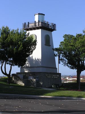 Illuminating the Way 2 of 2
This 'lighthouse' supports an AT&T Wireless and Sprint co-lo site in Dana Point, California, just adjacent to the Ritz Carlton Hotel.  Notice the antennas on the railing at the top, and the equipment room at the base.
