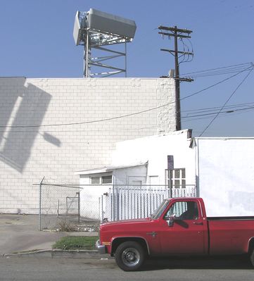 Sort-of Camo
This cell site is atop a two story commercial building.  Note the use of the old-style RF transparent covers in front of the antennas.
Keywords: camo