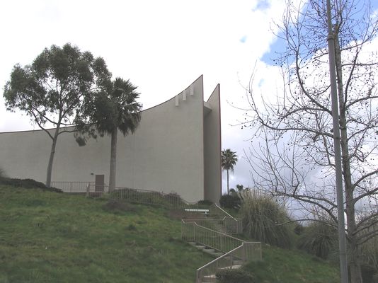 Sending out the word...to Interstate 10
Yet another church along a freeway that (likely) enjoys income in the thousands-of-dollars-per-month range.  This is a Nextel site near San Bernardino, California. 

The interesting and unusual element of this site is the placement of the antennas following the rise of the roofline.  In a typical configuration, the two outside antennas are used for reception, and the center antenna is used to transmit, and they're all on the same horizontal plane. 
Keywords: Nextel church rise rooline