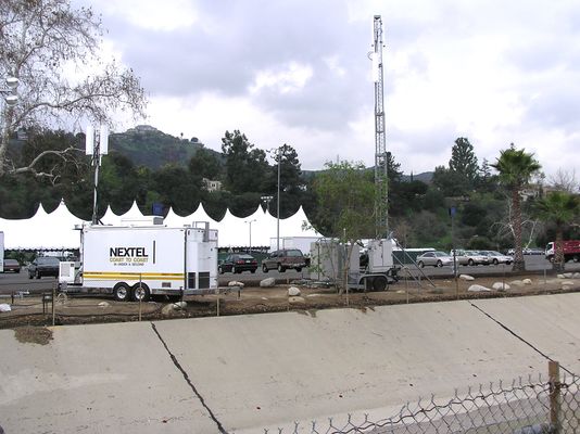 A small herd of cows...
Here are two COWs (cell-on-wheels) set up at the Rose Bowl in Pasadena, California, for "THE BIG GAME" on, well, January 1, 2005.   Nextel has a very pretty COW; Sprint's COW is a bit haggard.  Both have their own power generators.  See the detailed photos in this gallery.
Keywords: Sprint Nextel Cow Herd