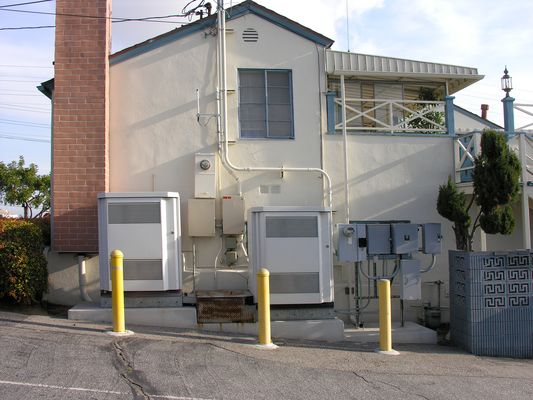 BTS Equipment, Bottom of Faux Chimney
This Cingular-built site in El Segundo, California, now owned by T-Mobile, overlooks LAX.  The building houses a mortuary.  In this picture you see the BTS equipment and the cables feeding to the bottom of the faux chimney.  A steeple on the LAX side of the building serves the airport. 
Keywords: cingular t-mobile lax el segundo faux chimney steeple