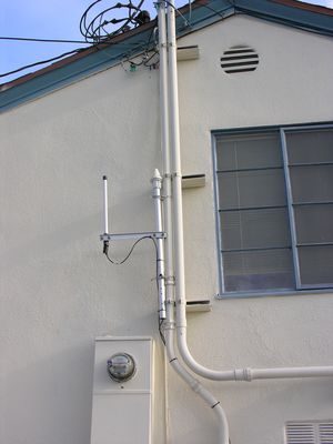 LMU/GPS - Unusual Configuration
This Cingular-built site in El Segundo, California, now owned by T-Mobile, overlooks LAX.  The building houses a mortuary.  In this picture you see a very unusual placement of the LMU antenna (left) and the GPS antenna (right) attached to the power riser.  This face of the building is to the south, so the LMU antenna is block for about 180 degrees of arc.  Clever, eh?
Keywords: cingular t-mobile lax el segundo faux chimney steeple