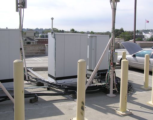 Park'n the Signal on the Roof
The cable wiring for this site leaves something to be desired.  Notice how the cables are attached to wood blocks.

PMBS>Cingular>T-Mobile at The Grand Long Beach Event Center, 4101 East Willow St.
Keywords: pbms cingular t-mobile long beach parking lot roof