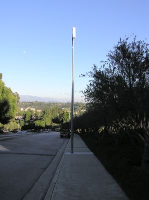 Sprint - Monopole with externally mounted single sector panel antenna
This is the single sector antenna used at Sprint's Mountaingate site.  The trench cut covers the conduit connection to the BTS equipment vault in the traffic median.  No, technically this isn't entirely a camouflaged site, but the majority of the site is, so that's why it's in our Camouflaged site gallery.
Keywords: Sprint