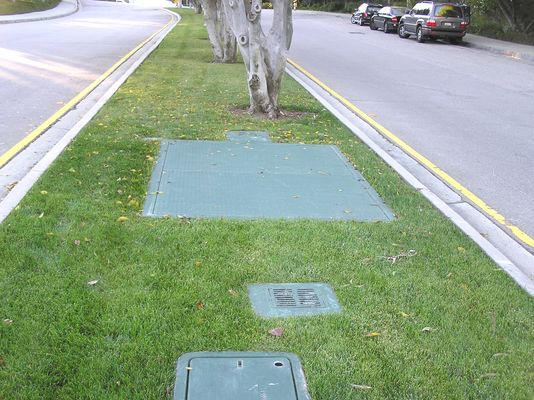 Sprint underground BTS equipment
This photo shows (foreground) the shallow vault used to route cables to/from the BTS; the BTS equipment vault (large double-doors); and the BTS equipment vault vents (grills near and far side of the BTS vault).  Located in the exclusive "Mountaingate" area of West Los Angeles.
Keywords: Sprint