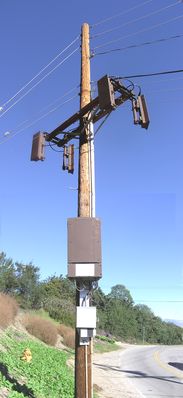 Two Sectors - One into a hillside!
This sprint site isn't for roadway coverage.  One sector (the one facing right in this photo) faces a group of homes.  The sector facing left in the photo points DIRECTLY INTO A HILLSIDE!  Very strange!  See the accompanying photo for more details about the aiming of the left-hand sector.
