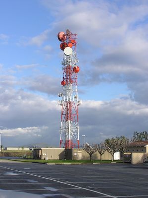 Cell site and Microwave Relay
This site is [b]not[/b] a mobile telephone switching office (MTSO).  Rather, its an aggregation point for microwave backhaul from other wireless sites.  Verizon and Nextel are co-located here.  

Why red and white?  This site is located adjacent to the Ontario, California airport.
Keywords: nextel verizon microwave backhaul ontario airport red white