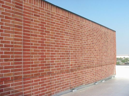 "Thick as a brick?"  #2 of 2
Faux brick penthouse wall.  Antennas behind the panel at the far end.  
Photo courtesy of [url=http://www.4peabody.com/]Peabody Engineering[/url].
Keywords: faux brick facing penthouse
