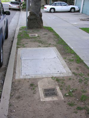 Two on a Stick
Sprint's BTS equipment is located in the large flush-to-grade vault.  It's flush vents bracket the BTS vault.  It's interesting to compare the small Sprint vents to the large Cingular vents at the same site.  (See the photos of Cingular's vents near this photo in the same gallery.)
Keywords: sprint cingular santa monica california wood utility light pole standard