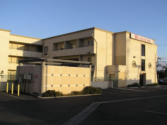 Restful Signal
Sprint's antennas are on the motel sign just out of the frame on the right side.  It's BTS equipment is located in the bricked area to the left center of this photo.  Notice the power panel, transfer switch, etc. on the left side of the enclosure.  From the street side, this enclosure is very well designed to blend in with the buidling.
Keywords: sprint azusa motel sign post