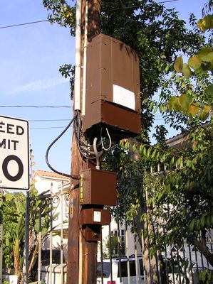 Sprint microcell - Base Station, Backhaul, and Powering
The base station is the large box. Below it is the interface box that extracts power from the coaxial cable backhaul system.  At the bottom, in the small box, is the power regulation transformer.  Note that this installation, in California, does not comply with CPUC General Order 95 as it has cables below 8 feet above ground that are not in conduit.
