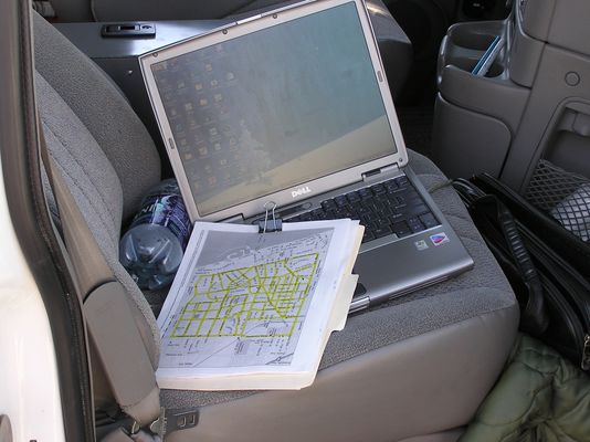 Drive Test Rover Ready To Run
Inside the cab of the drive test 'rover' is a portable computer connected to the output of the PCS signal strength receiver and the GPS receiver.  The computer records the data for later mapping.  The clipboard holds the predetermined route that the driver of the rover will cover during the test.
Keywords: Sprint drive test rover