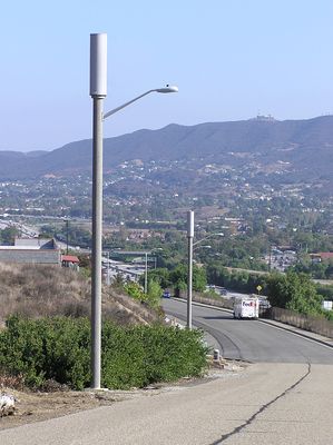 Sprint's Dual Light Standard Site
High above the US101 (Ventura Freeway) in Thousand Oaks sit these dual light standards. Two light standards provide three sectors of diversity coverage in this very high (RF) traffic area. The equipment is located in an underground vault. Rasnow Peak can be seen in the distance.
Keywords: sprint newbury park thousand oaks light standard dual
