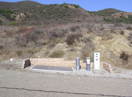 Underground BTS Equipment Vault
You're looking at a close-up view of one way that Sprint places its equipment underground.  The vents provide air flow.  The green pedestal is for the power meter.  The PVC tubing is for site drainage. This site is in the Newbury Park portion of Thousand Oaks, California.
Keywords: sprint newbury park thousand oaks underground BTS equipment vault
