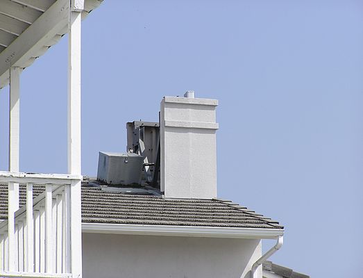 A faux 'faux chimney'
Cingular's faux chimney on the front of a real estate office is lacking the adequate coverage required to truly consider this to be a camouflaged site.  Notice the interesting (read: "ugly") cable entry box, and the fact that the panel antenna protrudes above the level of the faux chimney.  Not a good design.
Keywords: cingular tustin california faux chimney real estate remax newport blvd