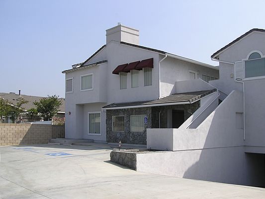 Faux 'faux chimney'
Cingular's faux chimney on the rear of a real estate office is a better design than the front faux chimney, yet this chimney suffers from one of the same faults as the front: the panel antenna protrudes above the level of the faux chimney.   
Keywords: cingular tustin california faux chimney real estate remax newport blvd