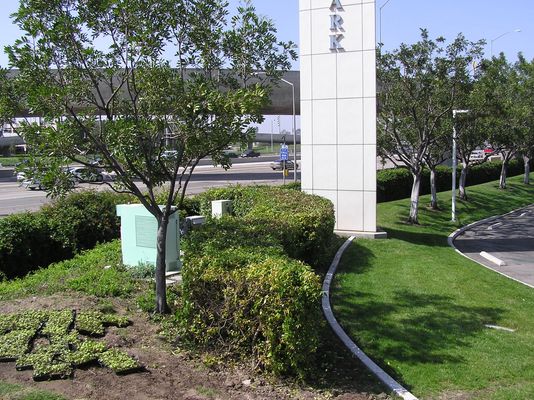 An Executive Quality Installation - Part 2
In the other photo of this site (elsewhere in this gallery) I didn't show the location of the equipment cabinets.  Based on requests from site users, here is a photo showing the equipment location behind the hedge.  
Keywords: Verizon camo monument irvine