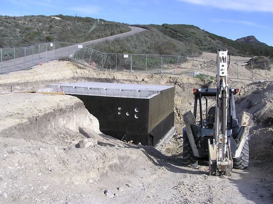Waterproofing the KMLT transmitter building
The external concrete forms and braces have been removed; the outside is treated for waterproofing; and the pre-cast holes to permit conduit/cable  entry are now visible.
Keywords: KMLT waterproofing
