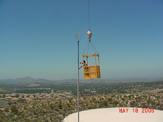 Painting on the Sky 2 of 6
Bill's in the bucket applying primer, then paint, to the PCV pole supporting KMLT's antenna. 

Photo thanks to Bill Cloutier.
Keywords: painting in the sky kmlt