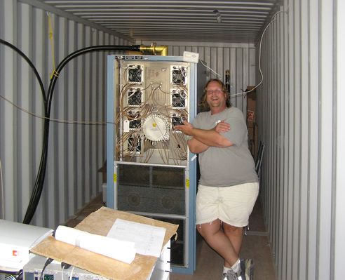 Chris Hicks, Chief Engineer
Chris Hicks is the Amaturo Group's RF engineer responsible for getting the new KMLT from dirt to on-the-air.  He's (proudly) standing by the KMLT transmitter, which is temporarily installed in a trailer while the permanent underground transmitter building is being constructed nearby.
Keywords: Chris Hicks KMLT-FM