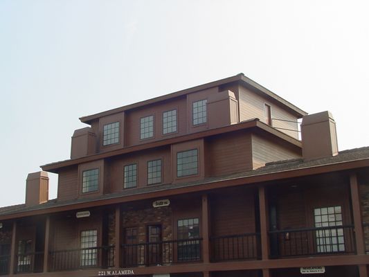 False 3rd story on office building
Antenna room constructted on top of an existing office building. Windows are not real, but instead painted upon translucent plastic materia.  Roof room accessible from access door on right end. 
Keywords: cellular wireless disguise camouflage hidden room